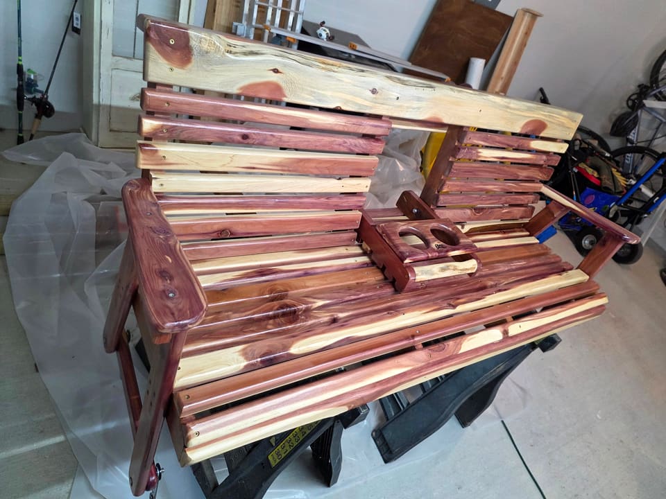 Angled view of the cedar swing showing the slat pattern and console