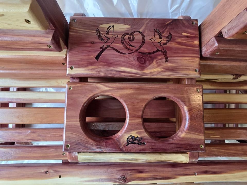 Close-up of the console face with two wood-burned doves and two cup holders