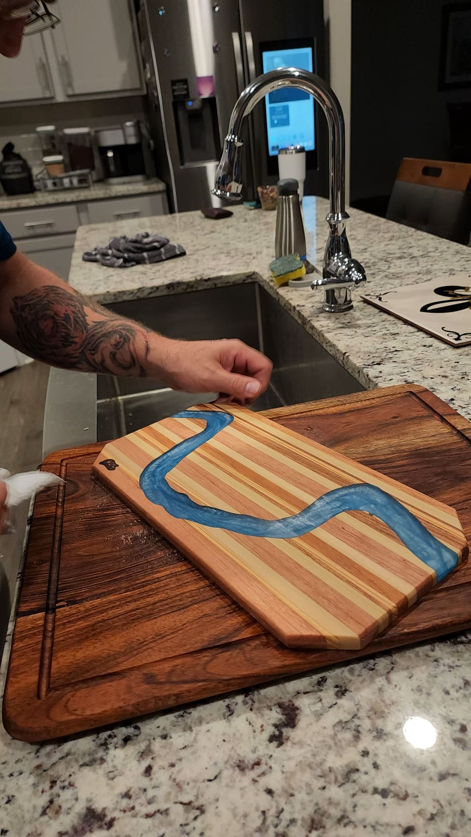 River board being finished at the sink with the epoxy channel visible