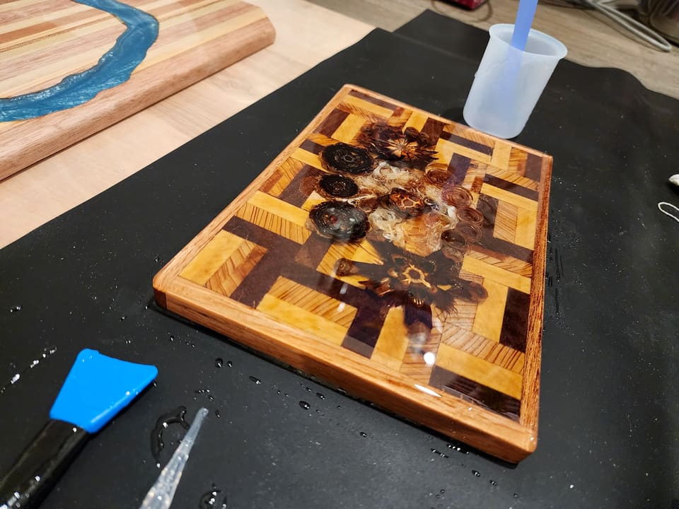 End-grain serving board with pressed flowers set in clear resin