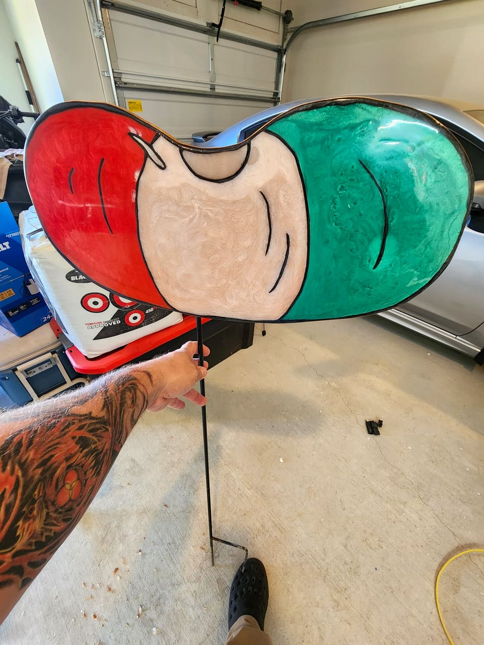 The watermelon slice in the workshop, held up for scale