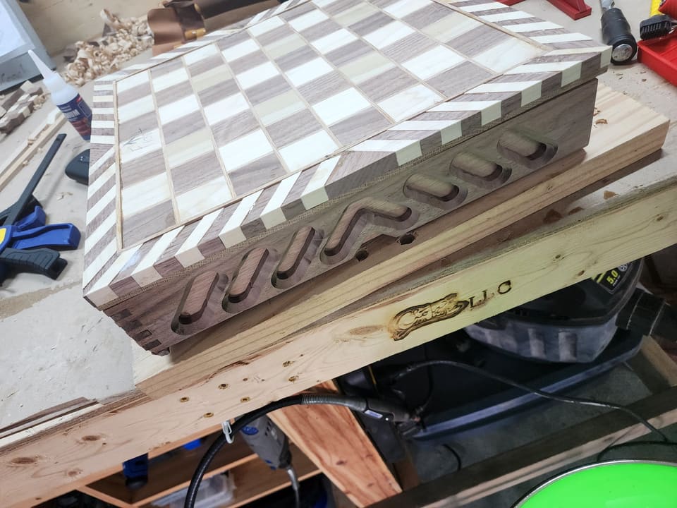 Chess board glue-up in progress on the workbench, showing the checkerboard end grain