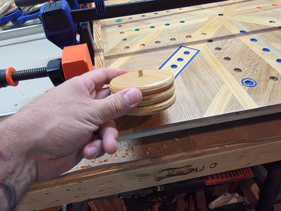 Round spinner pieces held over the finished marble board