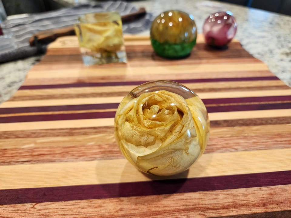 Ivory rose preserved in a clear resin sphere