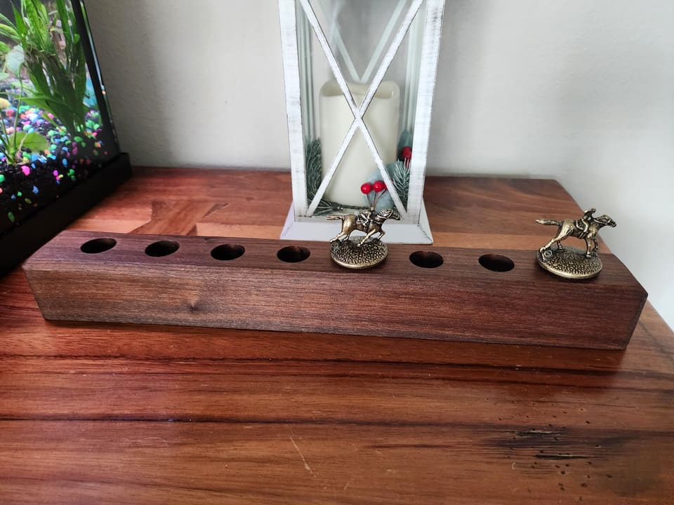 Long walnut display stand with drilled holders for small figures