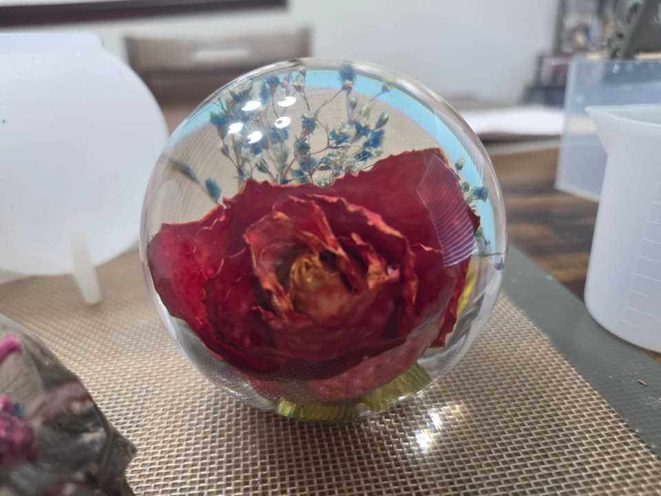 Front view of the red rose inside the clear resin sphere