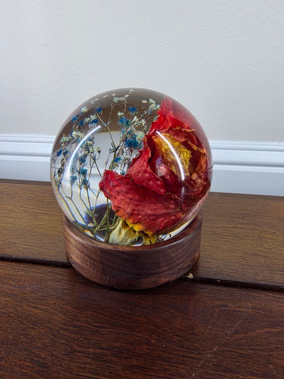 Closer view of the red rose resin orb on its round base