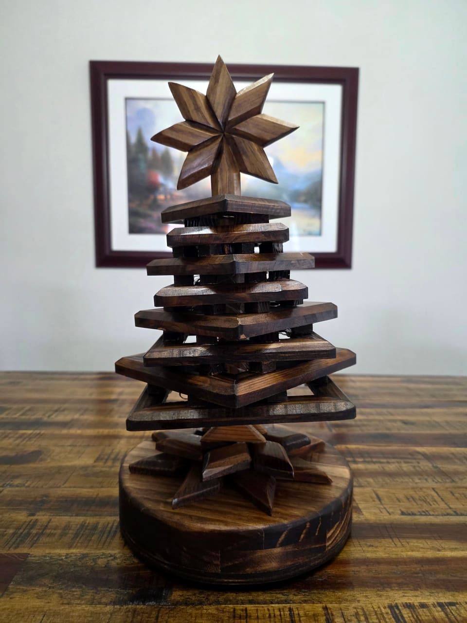 Side view of the stacked wood tree showing the rotated square layers and round base