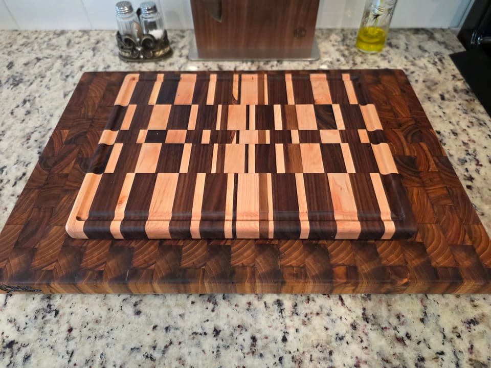 End-grain cutting board in light and dark wood with an irregular stripe pattern